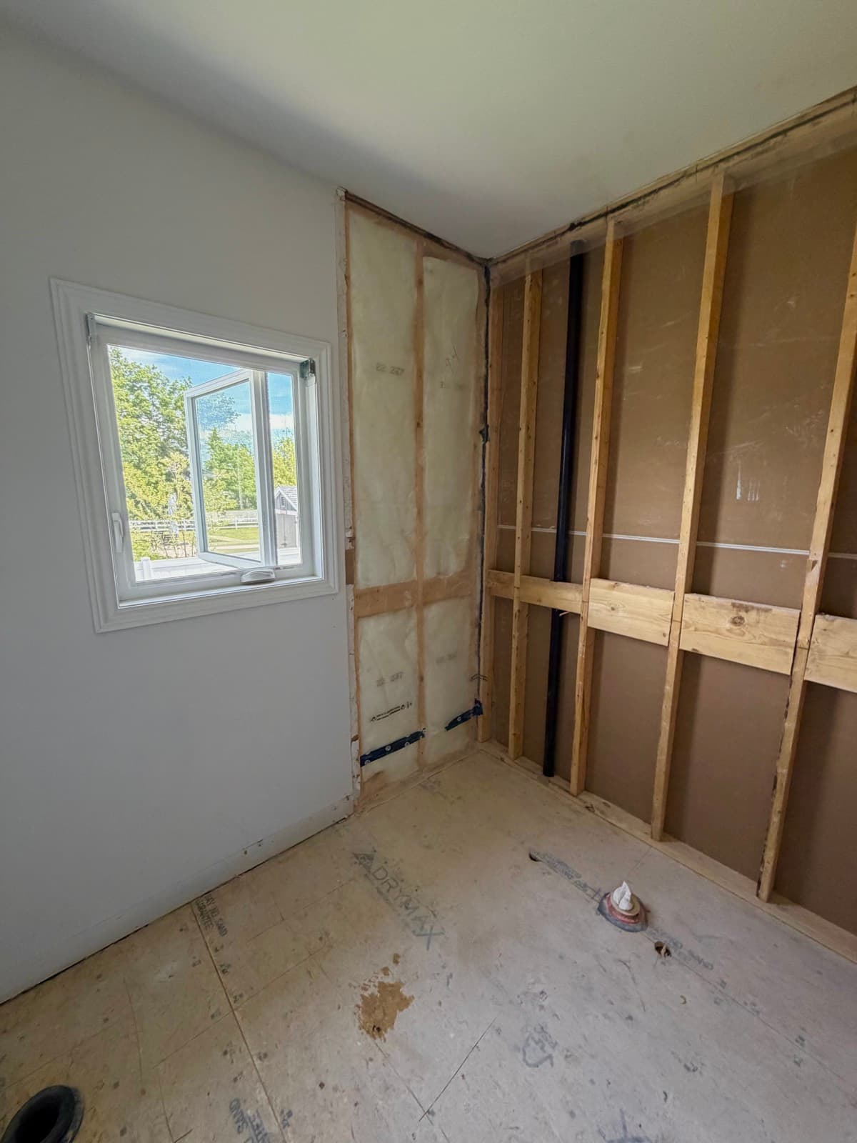 Bathroom stripped back to the studs and subfloor, ready for a rebuild